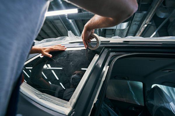 Professional front window tint in California being installed with a precision squeegee.